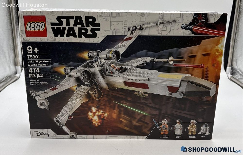 A ShopGoodwill listing photo of a sealed LEGO Star Wars set, 75301 Luke Skywalker's X-Wing Fighter, showing the box art and its four minifigures